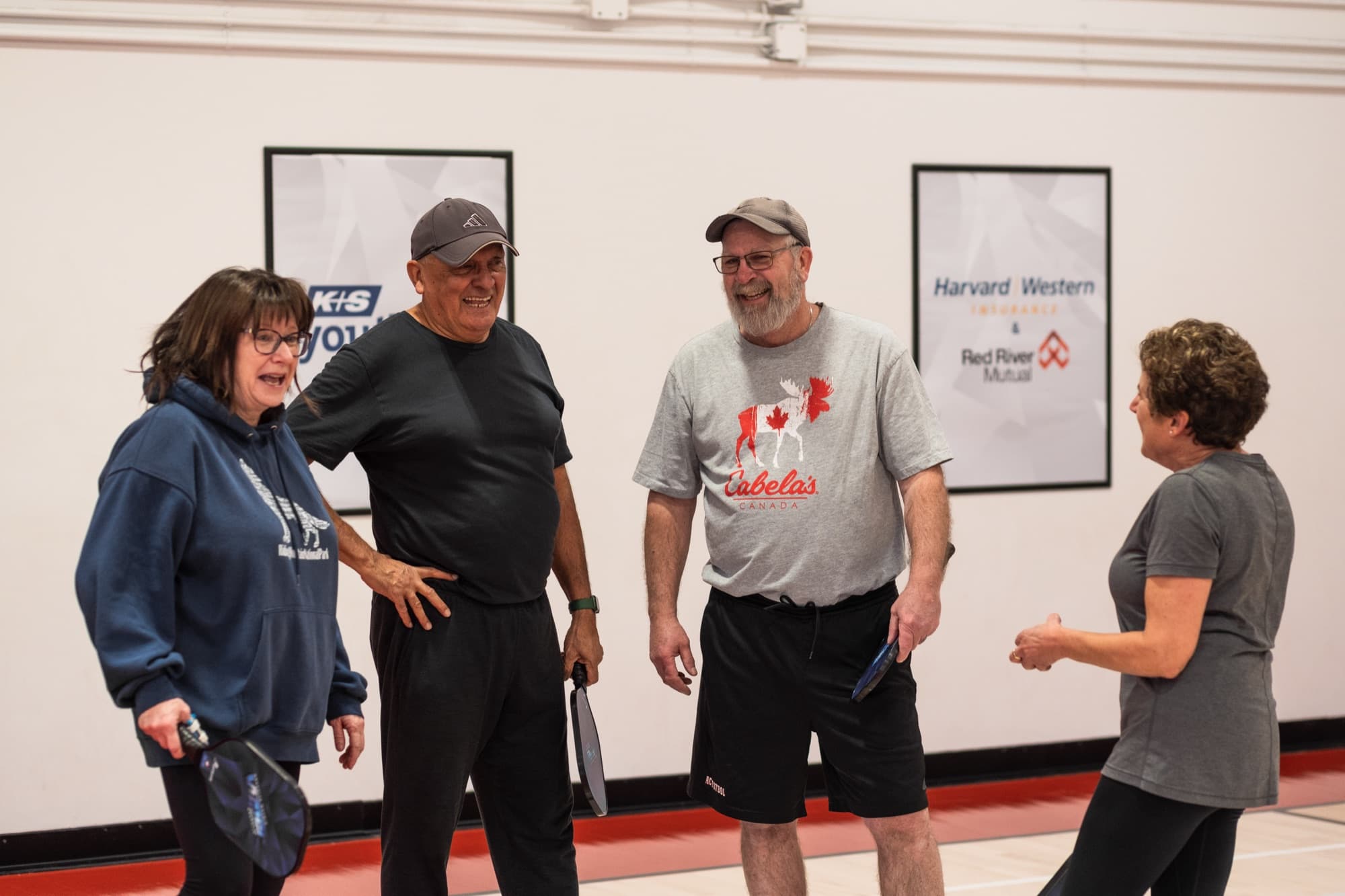 Four Prairie Pickleball members standing on the court in Regina with their paddles